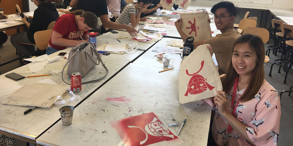 Students working on tote bags